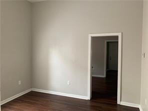 spare room featuring dark wood-type flooring