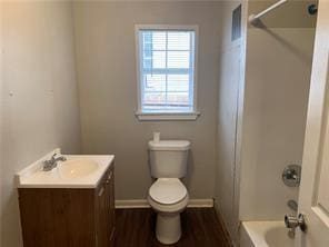 full bathroom featuring wood-type flooring, shower / bathing tub combination, vanity, and toilet