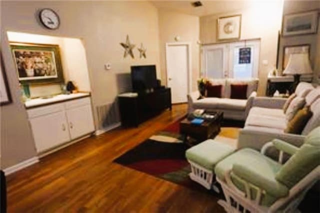 living room with dark hardwood / wood-style flooring