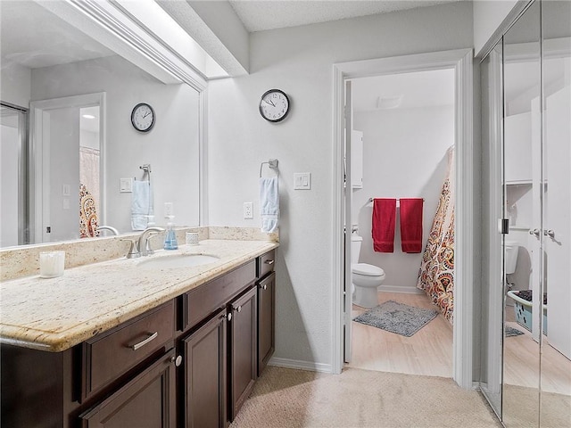 bathroom featuring hardwood / wood-style floors, vanity, and toilet