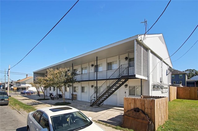 3300 Baronne St, New Orleans, LA 70115 - view of building exterior featuring a residential view, fence, and stairway