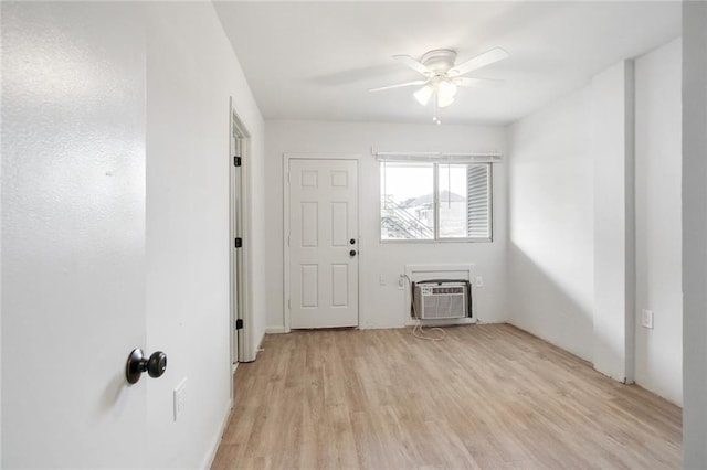 interior space with ceiling fan, light hardwood / wood-style floors, and a wall unit AC