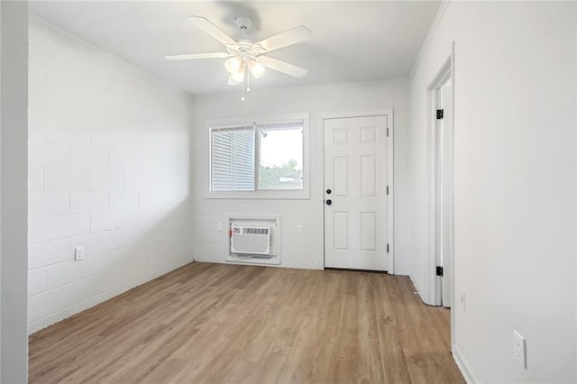 unfurnished room featuring light hardwood / wood-style flooring, an AC wall unit, and ceiling fan