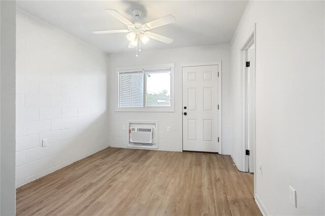 3300 Baronne St, New Orleans, LA 70115 - empty room featuring a ceiling fan, a wall mounted AC, crown molding, and light wood finished floors