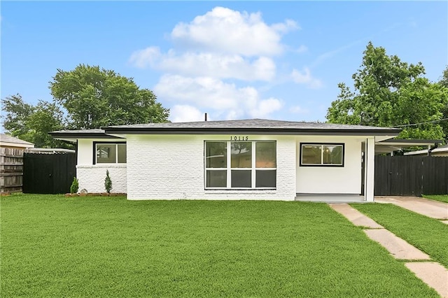 rear view of property with a yard