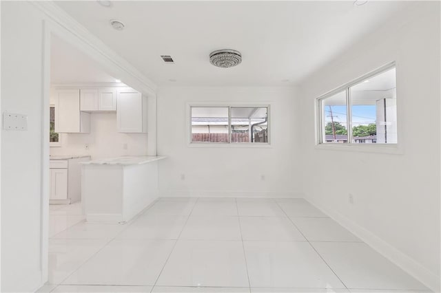 tiled spare room with a wealth of natural light