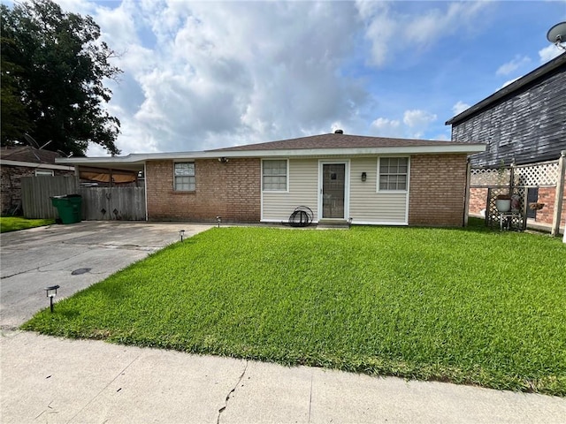 ranch-style home with a carport and a front lawn