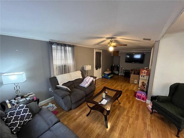 living room with wood-type flooring and ceiling fan