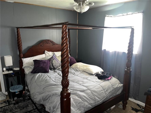 carpeted bedroom with wooden walls