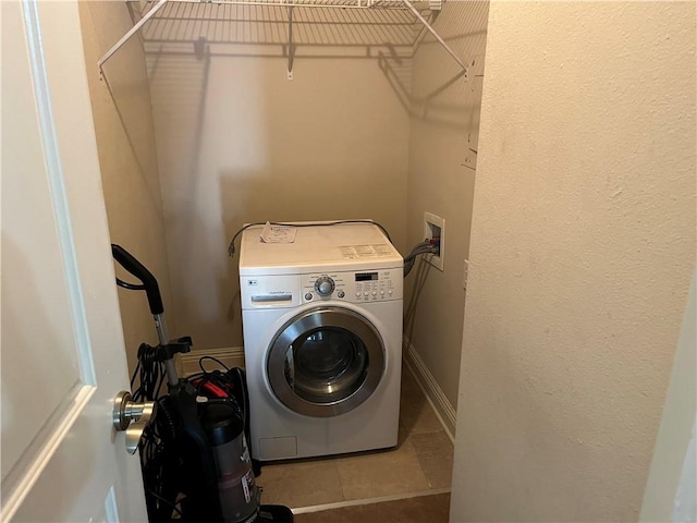 clothes washing area featuring tile flooring and washer / clothes dryer