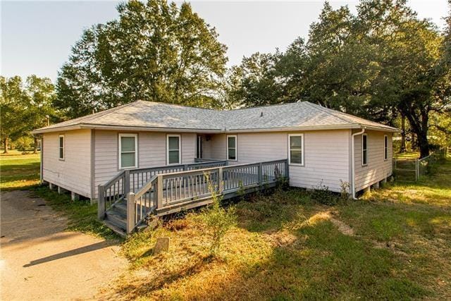 back of house with a yard and a deck