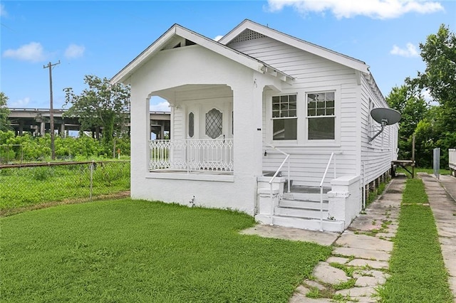 bungalow-style home featuring a front lawn