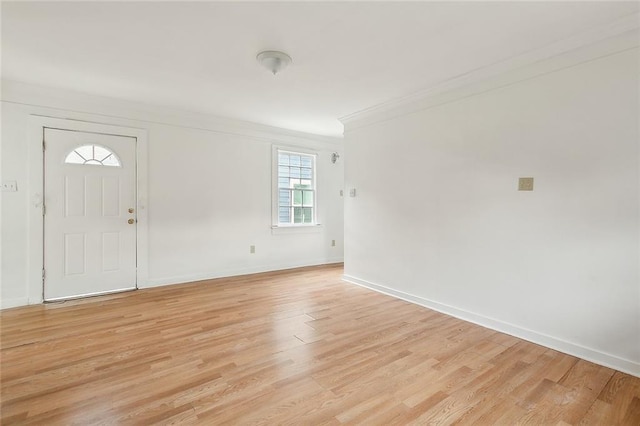 foyer featuring crown molding and light wood-type flooring