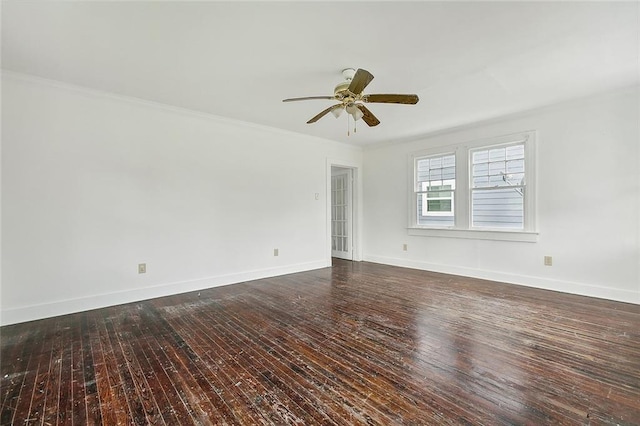 spare room featuring crown molding, dark wood-type flooring, and ceiling fan