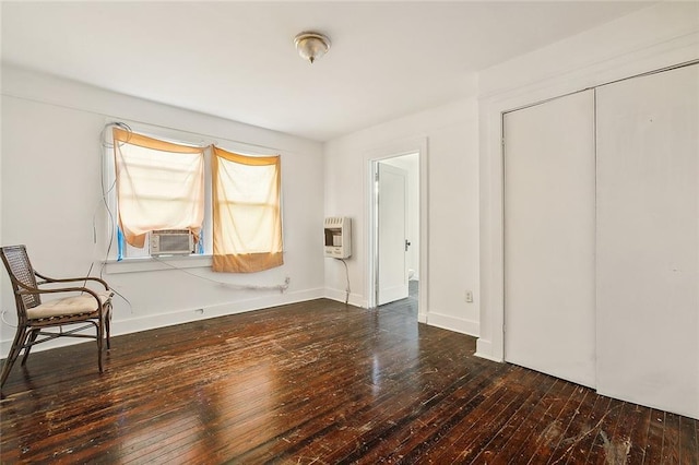 interior space with heating unit, a closet, cooling unit, and dark hardwood / wood-style floors