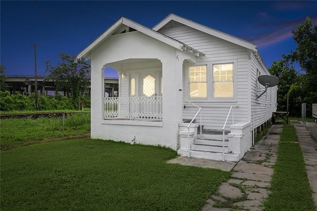 exterior space with a porch and a lawn