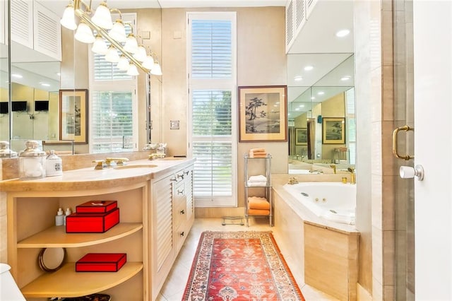 bathroom with tile flooring, tiled bath, and vanity