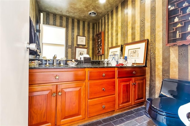 bathroom with tile floors, toilet, and vanity