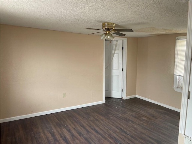 spare room with dark hardwood / wood-style floors, a textured ceiling, and ceiling fan