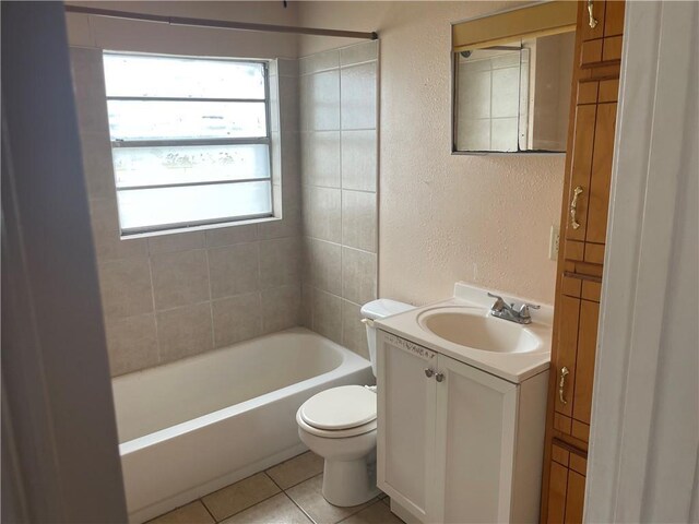 full bathroom featuring toilet, tile flooring, tiled shower / bath combo, and oversized vanity