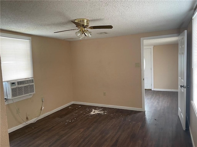 unfurnished room with ceiling fan, cooling unit, a textured ceiling, and dark hardwood / wood-style flooring