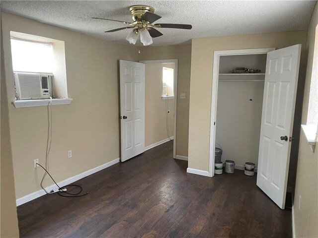 unfurnished bedroom with ceiling fan, a textured ceiling, and dark wood-type flooring