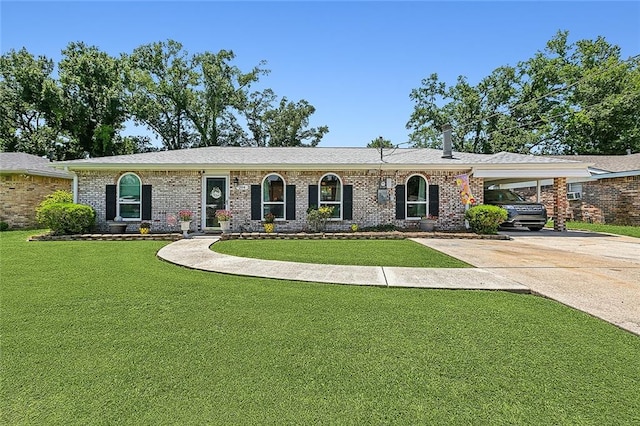 ranch-style house with brick siding, a front lawn, a carport, and driveway