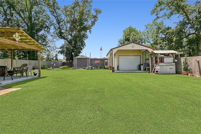 view of yard with an outbuilding, a fenced backyard, and a patio area