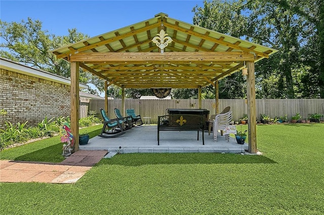 view of patio / terrace with a gazebo, an outdoor living space, and a fenced backyard