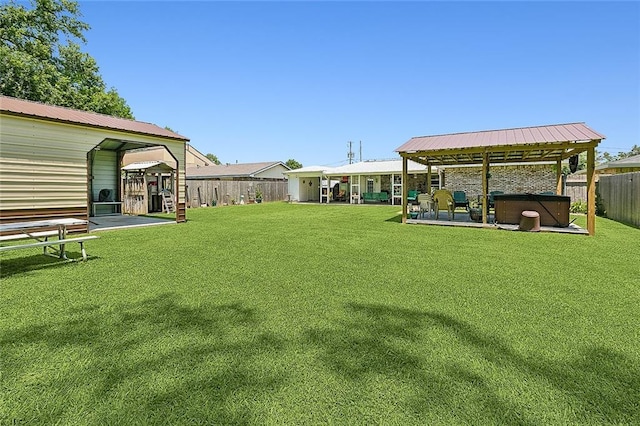 view of yard featuring a patio, a hot tub, and a fenced backyard