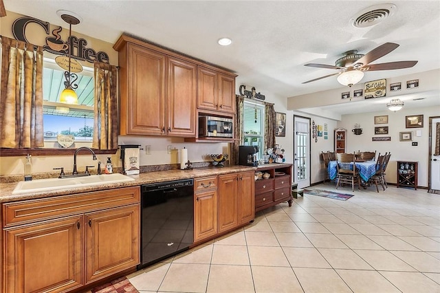 kitchen with visible vents, a sink, black dishwasher, stainless steel microwave, and brown cabinets
