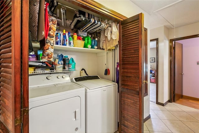 washroom with washing machine and dryer and light tile floors