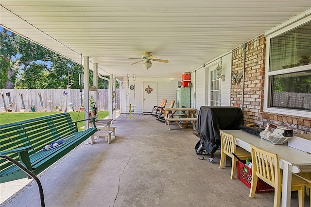 view of patio / terrace with ceiling fan and fence