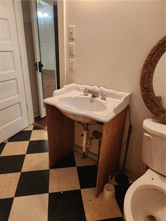 bathroom featuring toilet and tile patterned floors