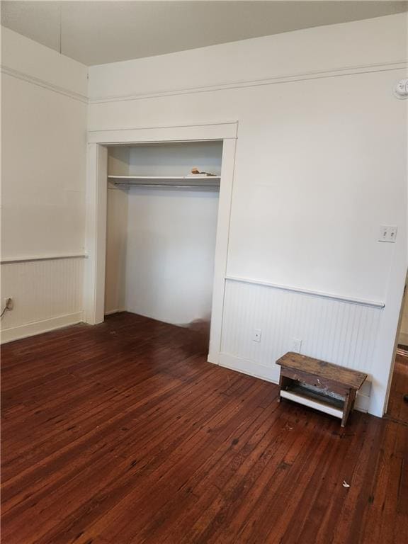 unfurnished bedroom featuring hardwood / wood-style flooring and a closet