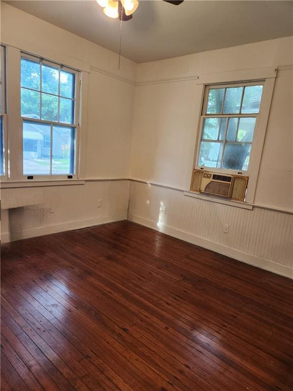 spare room with dark hardwood / wood-style floors, cooling unit, and ceiling fan