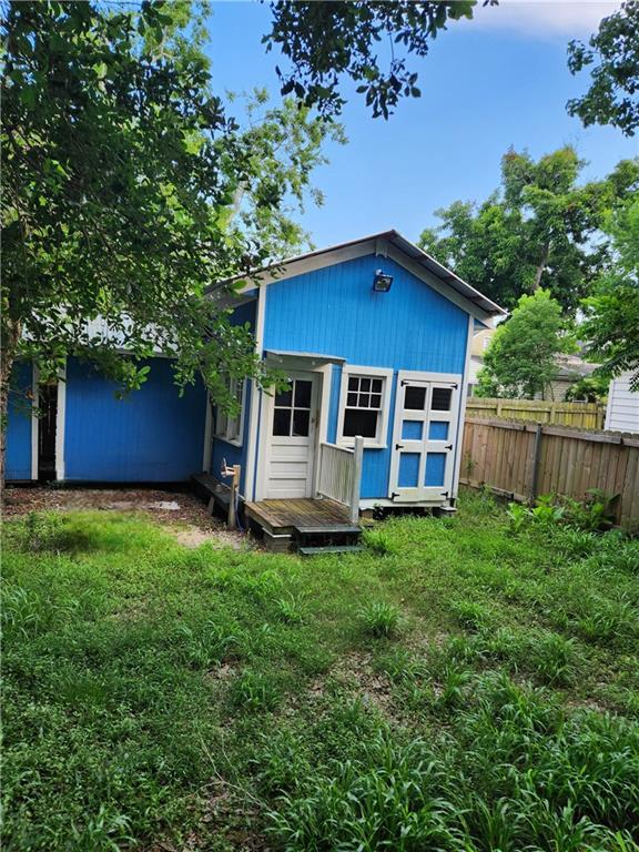 view of outbuilding with fence and an outdoor structure