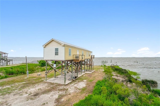 rear view of house featuring a water view