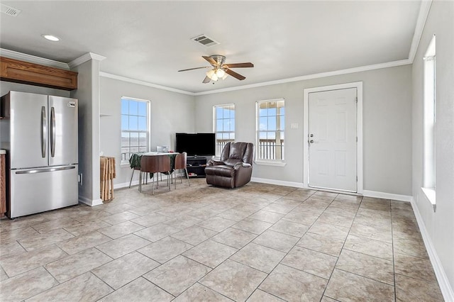 interior space featuring ceiling fan, a healthy amount of sunlight, and ornamental molding