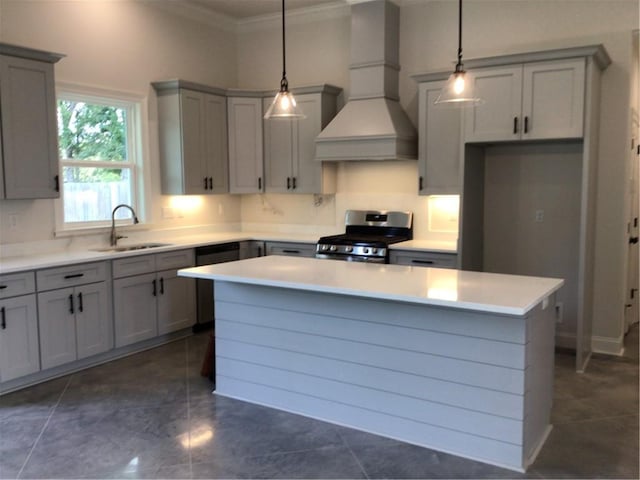 kitchen featuring dark tile patterned floors, premium range hood, stainless steel range with gas cooktop, and a kitchen island