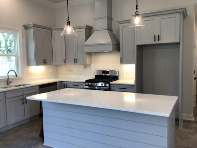 kitchen with a center island, sink, gas range, custom exhaust hood, and dark tile patterned floors