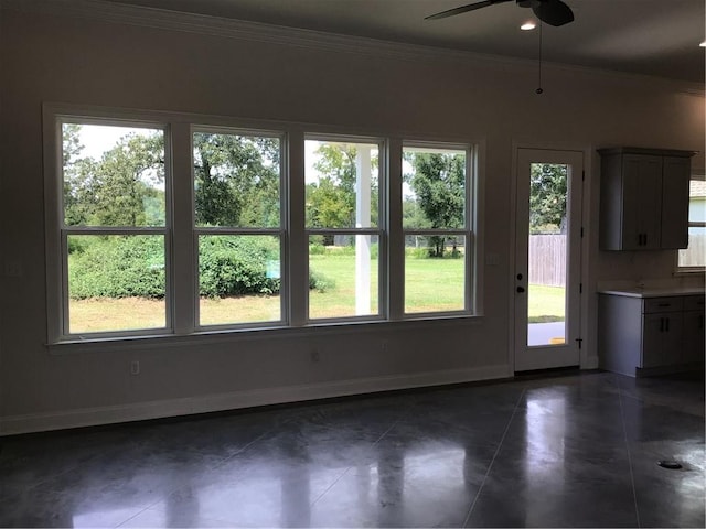 unfurnished dining area featuring dark tile patterned floors and a healthy amount of sunlight