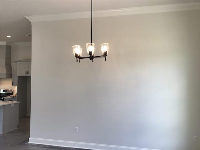 unfurnished dining area featuring an inviting chandelier, ornamental molding, and tile patterned flooring