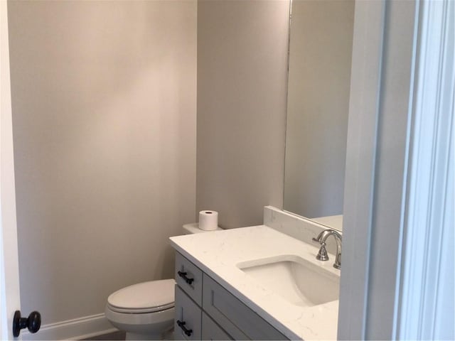 bathroom with toilet and vanity