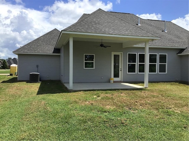 rear view of property featuring ceiling fan, central AC, a patio area, and a yard