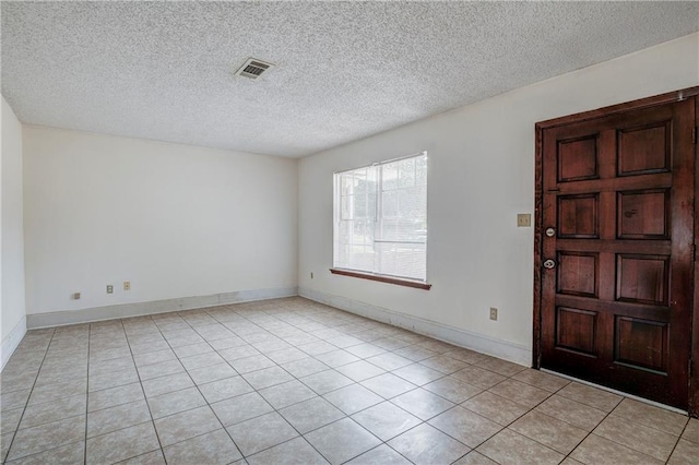 tiled entrance foyer with a textured ceiling