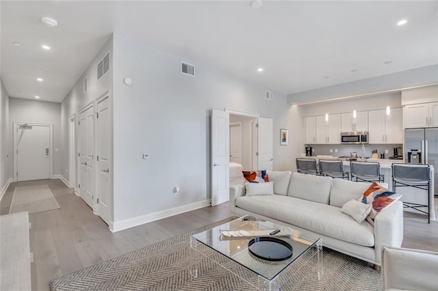 living room with light hardwood / wood-style floors