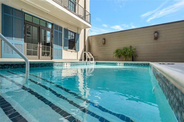 view of pool with french doors