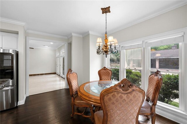 dining space with an inviting chandelier, dark hardwood / wood-style flooring, and ornamental molding