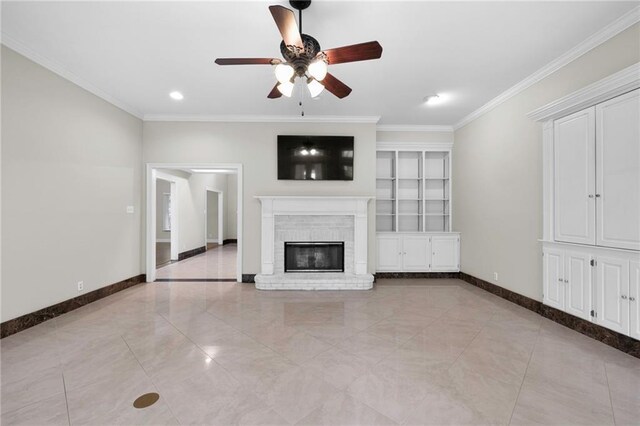 unfurnished living room featuring crown molding, built in features, a brick fireplace, ceiling fan, and light tile floors